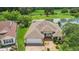 An aerial view of a single story home with a brick driveway, an attached garage, and beautiful landscaping at 2880 Manor Downs, The Villages, FL 32162
