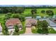 Aerial view of homes nestled on a manicured lawn near a pond at 2880 Manor Downs, The Villages, FL 32162