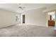 Bright bedroom featuring vaulted ceiling, carpet, and large windows overlooking the yard at 2880 Manor Downs, The Villages, FL 32162