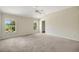 Spacious carpeted bedroom with vaulted ceilings and two windows letting in lots of natural light at 2880 Manor Downs, The Villages, FL 32162
