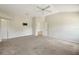 Carpeted bedroom with a ceiling fan, two doors, and an entertainment center mount on the wall at 2880 Manor Downs, The Villages, FL 32162