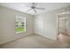 Bright bedroom with natural light, carpet, and closet at 2880 Manor Downs, The Villages, FL 32162