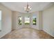 Bright dining room with recessed ceilings and three large windows providing natural light at 2880 Manor Downs, The Villages, FL 32162