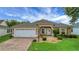 Charming single-story home featuring a two-car garage and well-manicured lawn at 2880 Manor Downs, The Villages, FL 32162
