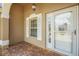 Front porch features brick flooring and an elegant white trimmed door at 2880 Manor Downs, The Villages, FL 32162