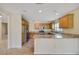 Updated kitchen with stainless steel appliances, light wood cabinets and granite countertops at 2880 Manor Downs, The Villages, FL 32162