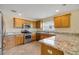 Bright kitchen featuring wooden cabinets, stainless steel appliances, and granite countertops at 2880 Manor Downs, The Villages, FL 32162