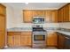 Spacious kitchen with stainless steel appliances, light wood cabinets, and granite counters at 2880 Manor Downs, The Villages, FL 32162