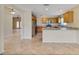 Open kitchen with wooden cabinets, stainless steel appliances, and granite countertops at 2880 Manor Downs, The Villages, FL 32162