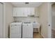 Laundry area with a washer, dryer, utility sink and storage cabinets at 2880 Manor Downs, The Villages, FL 32162