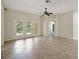 Living room featuring tile flooring, ceiling fan and access to the backyard at 2880 Manor Downs, The Villages, FL 32162