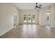 Spacious living room features tile flooring, ceiling fan, and access to the outside at 2880 Manor Downs, The Villages, FL 32162