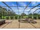 View of the screened in lanai with water feature, stamped concrete and view of the yard at 2880 Manor Downs, The Villages, FL 32162