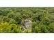 Home aerial view surrounded by lush greenery, showcasing the pool and screened-in outdoor area at 32511 County Road 437, Sorrento, FL 32776