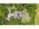 Aerial view of the home nestled in lush greenery, featuring a pool and expansive outdoor space at 32511 County Road 437, Sorrento, FL 32776