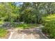 Landscaped backyard with brick pathways and seating, creating a serene outdoor environment at 32511 County Road 437, Sorrento, FL 32776