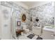 Bathroom features toile wallpaper, classic fixtures, and a glass shower door at 32511 County Road 437, Sorrento, FL 32776