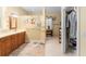 Spacious main bathroom with vanity, nautical decor, and walk-in closet at 32511 County Road 437, Sorrento, FL 32776