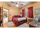Cozy bedroom features wood floors, natural light, and classic decor at 32511 County Road 437, Sorrento, FL 32776