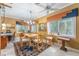 Cozy dining room features a wooden table, six chairs, and many windows at 32511 County Road 437, Sorrento, FL 32776