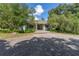 Charming home featuring a stone pathway leading to a covered front porch with classic columns at 32511 County Road 437, Sorrento, FL 32776