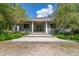 Charming home featuring a stone pathway leading to a covered front porch with classic columns at 32511 County Road 437, Sorrento, FL 32776
