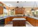 Spacious kitchen featuring wood cabinets, an island, and modern appliances at 32511 County Road 437, Sorrento, FL 32776