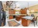 Bright kitchen with wood cabinets, an island, and modern appliances at 32511 County Road 437, Sorrento, FL 32776