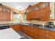 Kitchen area showcasing wood cabinets, countertops, and under cabinet lighting at 32511 County Road 437, Sorrento, FL 32776