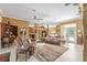 Inviting living room featuring comfortable couches, tile floors, and many decorations at 32511 County Road 437, Sorrento, FL 32776
