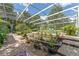 Expansive screened pool area with garden beds, merging outdoor living and natural beauty at 32511 County Road 437, Sorrento, FL 32776