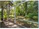 Tranquil screened patio with lush greenery, offering a private outdoor living space at 32511 County Road 437, Sorrento, FL 32776