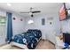 This bedroom features blue walls, a ceiling fan, and a bed with a rocket ship themed comforter at 3309 Paisley Cir, Orlando, FL 32817