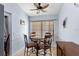 Cozy dining area with a round table, bar stools, neutral decor, and natural light from the window at 3309 Paisley Cir, Orlando, FL 32817