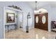 Elegant foyer with marble floors, a decorative mirror, and a view into the adjacent room through an open doorway at 3309 Paisley Cir, Orlando, FL 32817