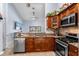 Kitchen with granite countertops, tile backsplash, stainless appliances, and wood cabinets with floral accents at 3309 Paisley Cir, Orlando, FL 32817