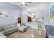 Bright and open living room with tile flooring, neutral decor, and views into the kitchen and dining area at 3309 Paisley Cir, Orlando, FL 32817