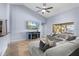 Bright living room with tile flooring, high ceilings, a ceiling fan, and a comfortable grey sectional sofa at 3309 Paisley Cir, Orlando, FL 32817