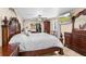 Spacious main bedroom featuring a king-size bed, a large dresser, and a ceiling fan for comfort at 3309 Paisley Cir, Orlando, FL 32817