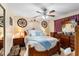 Elegantly furnished main bedroom with a wooden bed frame, ceiling fan, and dual nightstands at 3309 Paisley Cir, Orlando, FL 32817