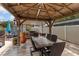 Covered outdoor kitchen featuring a built-in grill, sink, and dining table for an entertainer's delight at 3309 Paisley Cir, Orlando, FL 32817