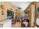 Inviting covered patio featuring wicker furniture, tiled flooring, and an open view at 3309 Paisley Cir, Orlando, FL 32817