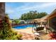 Fenced-in backyard pool area with a swing and beautiful landscaping and hardscaping at 3309 Paisley Cir, Orlando, FL 32817