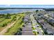 Aerial view showcases the home's location near a scenic lake in a well-planned community, featuring a manicured lawn at 3467 Buoy Cir, Winter Garden, FL 34787