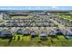 A picturesque community showcasing well-spaced homes, lush greenery, and community pools under clear skies at 3467 Buoy Cir, Winter Garden, FL 34787