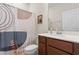Bathroom features a modern vanity, patterned shower curtain, and ample space at 3467 Buoy Cir, Winter Garden, FL 34787
