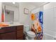 Bathroom with a vanity, toilet, shower, and colorful shower curtain at 3467 Buoy Cir, Winter Garden, FL 34787