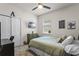 This cozy bedroom features a window, ceiling fan, and closet with a desk and dresser at 3467 Buoy Cir, Winter Garden, FL 34787