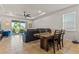 Open-concept dining room with stylish furniture, ceiling fan, and seamless flow to the living area at 3467 Buoy Cir, Winter Garden, FL 34787
