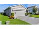 Charming home featuring a two-car garage, well-manicured lawn, and tidy landscaping at 3467 Buoy Cir, Winter Garden, FL 34787